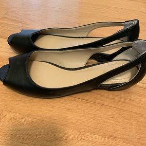 Black leather open toe kitten heel shoes.